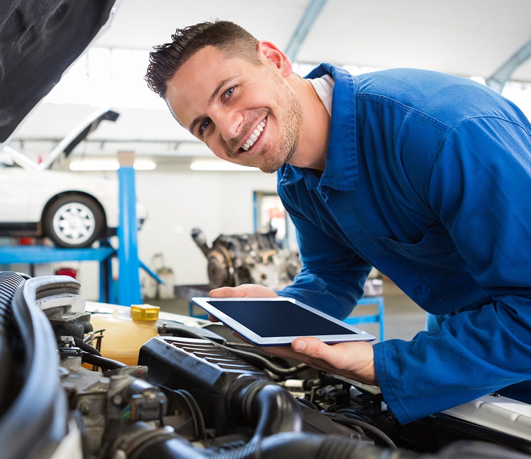 Service expert technician inspecting a car